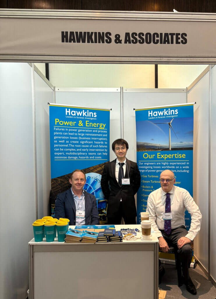 Image of Hawkins investigators Ben Adams, Albert Law and Stephen Rowbotham on hand at the Hawkins booth