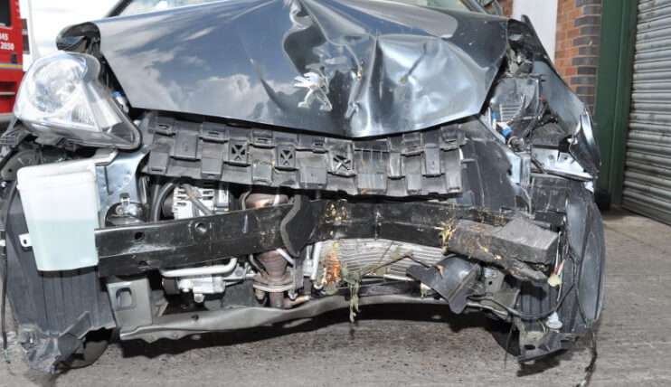front of car completely damaged following rtc